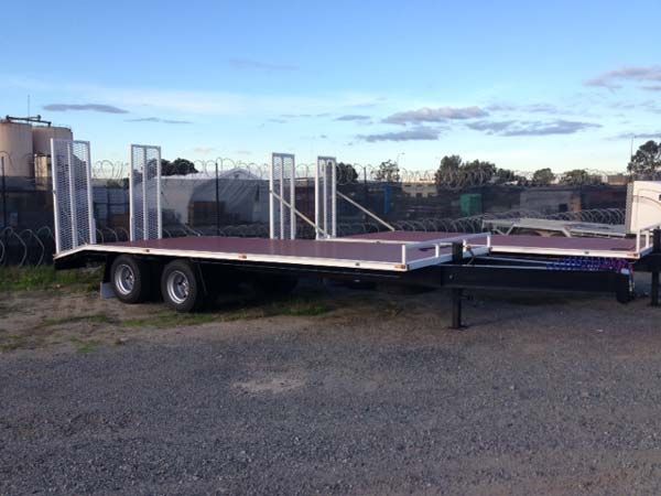 A Flatbed Trailer Is Parked in A Gravel Lot — Welshpool, WA — PTE Group Pty Ltd