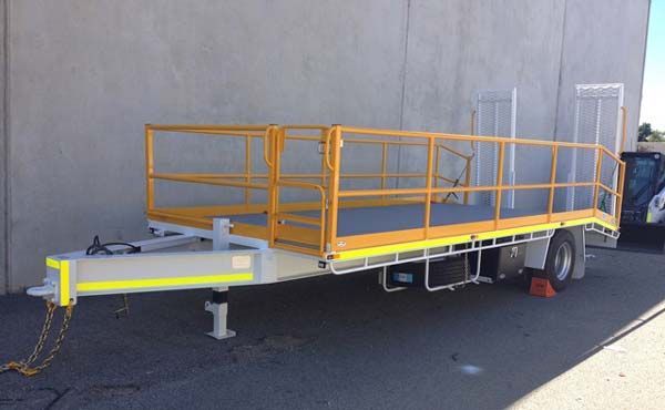 A Trailer with A Yellow Railing Is Parked in Front of A Building — Welshpool, WA — PTE Group Pty Ltd