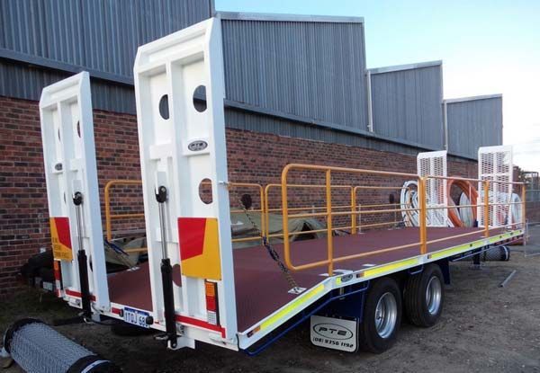 A Trailer with The Word Ptb on The Side Is Parked in Front of A Brick Building — Welshpool, WA — PTE Group Pty Ltd