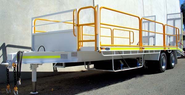 A Trailer with A Yellow Railing Is Parked in Front of A Building — Welshpool, WA — PTE Group Pty Ltd
