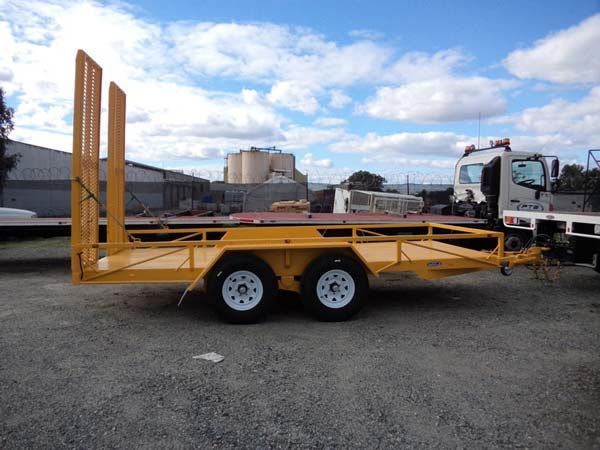 A Yellow Trailer Is Parked Next to A Truck in A Gravel Lot — Welshpool, WA — PTE Group Pty Ltd