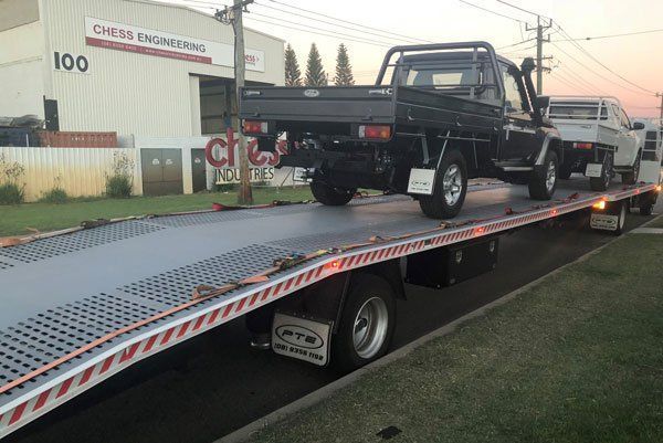 A Truck Is Sitting on Top of A Flatbed Tow Truck — Welshpool, WA — PTE Group Pty Ltd