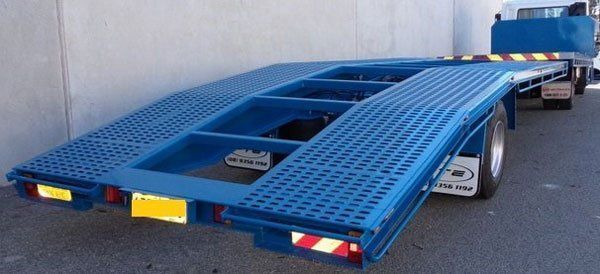 A Blue Tow Truck Is Parked in Front of A Building — Welshpool, WA — PTE Group Pty Ltd