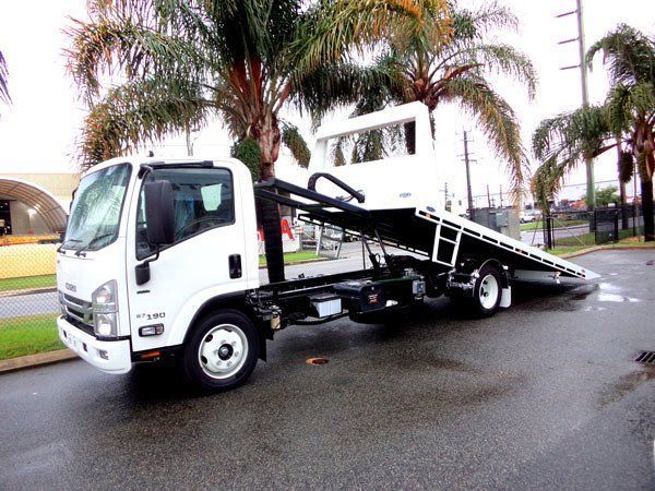 A White Tow Truck Is Parked in A Parking Lot Next to Palm Trees — Welshpool, WA — PTE Group Pty Ltd