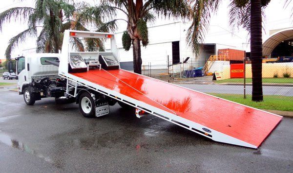 A Red and White Tow Truck Is Parked on The Side of The Road — Welshpool, WA — PTE Group Pty Ltd