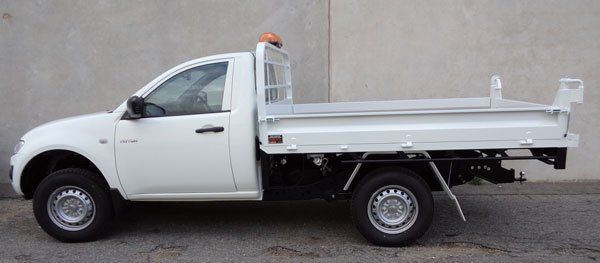 A White Truck with A Dump Bed Is Parked on The Side of The Road — Welshpool, WA — PTE Group Pty Ltd