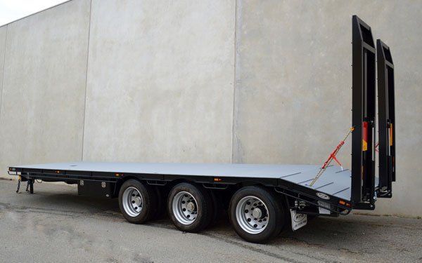 A Flatbed Trailer Is Parked in Front of A Concrete Wall — Welshpool, WA — PTE Group Pty Ltd