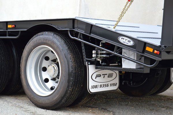 A Semi Truck with A Ramp Attached to The Back of It Is Parked on The Side of The Road — Welshpool, WA — PTE Group Pty Ltd