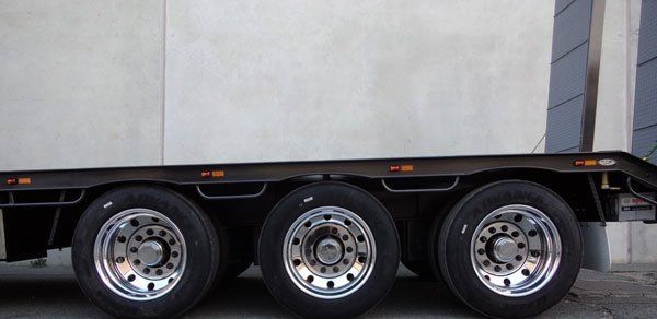 A Truck with Three Tires and Chrome Wheels Is Parked in Front of A Building — Welshpool, WA — PTE Group Pty Ltd