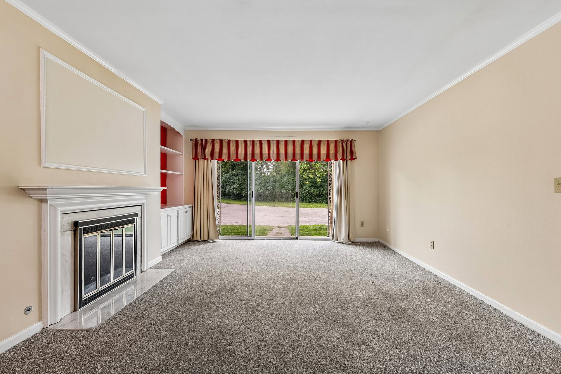 Photo of a living room with a fireplace and plenty of natural lighting