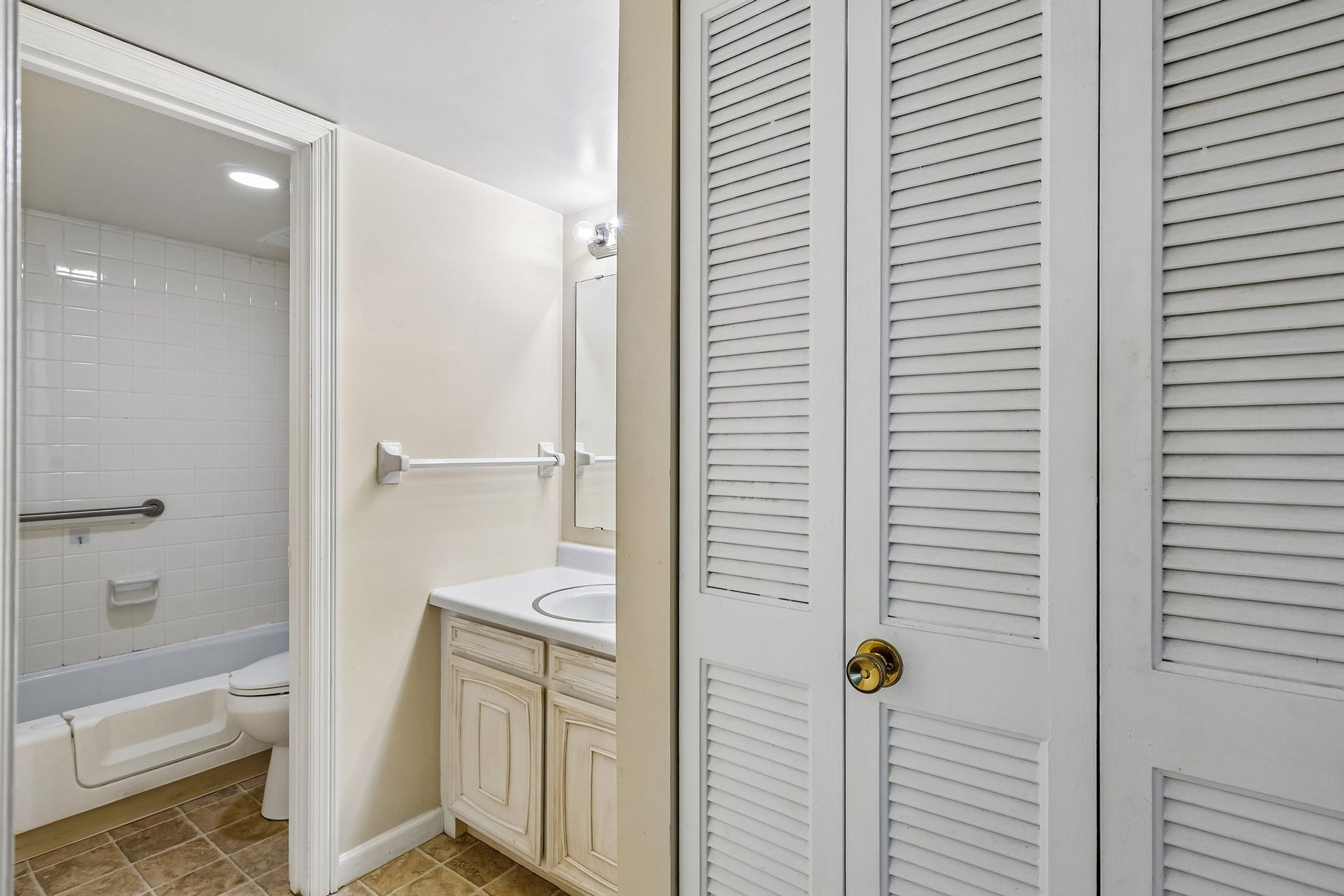 Photo of a bathroom with a linen closet next to it