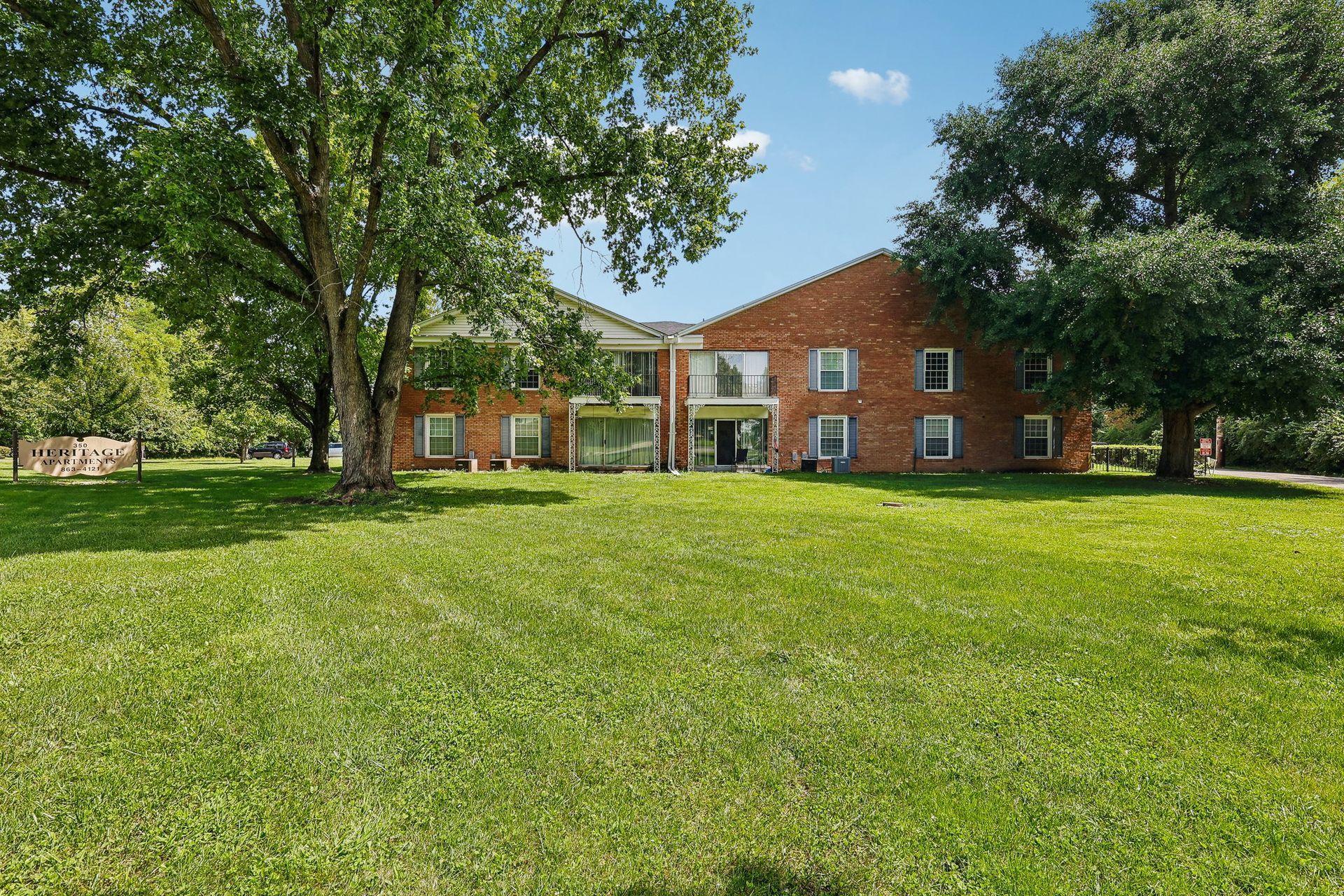 Photo of an apartment building with trees around it
