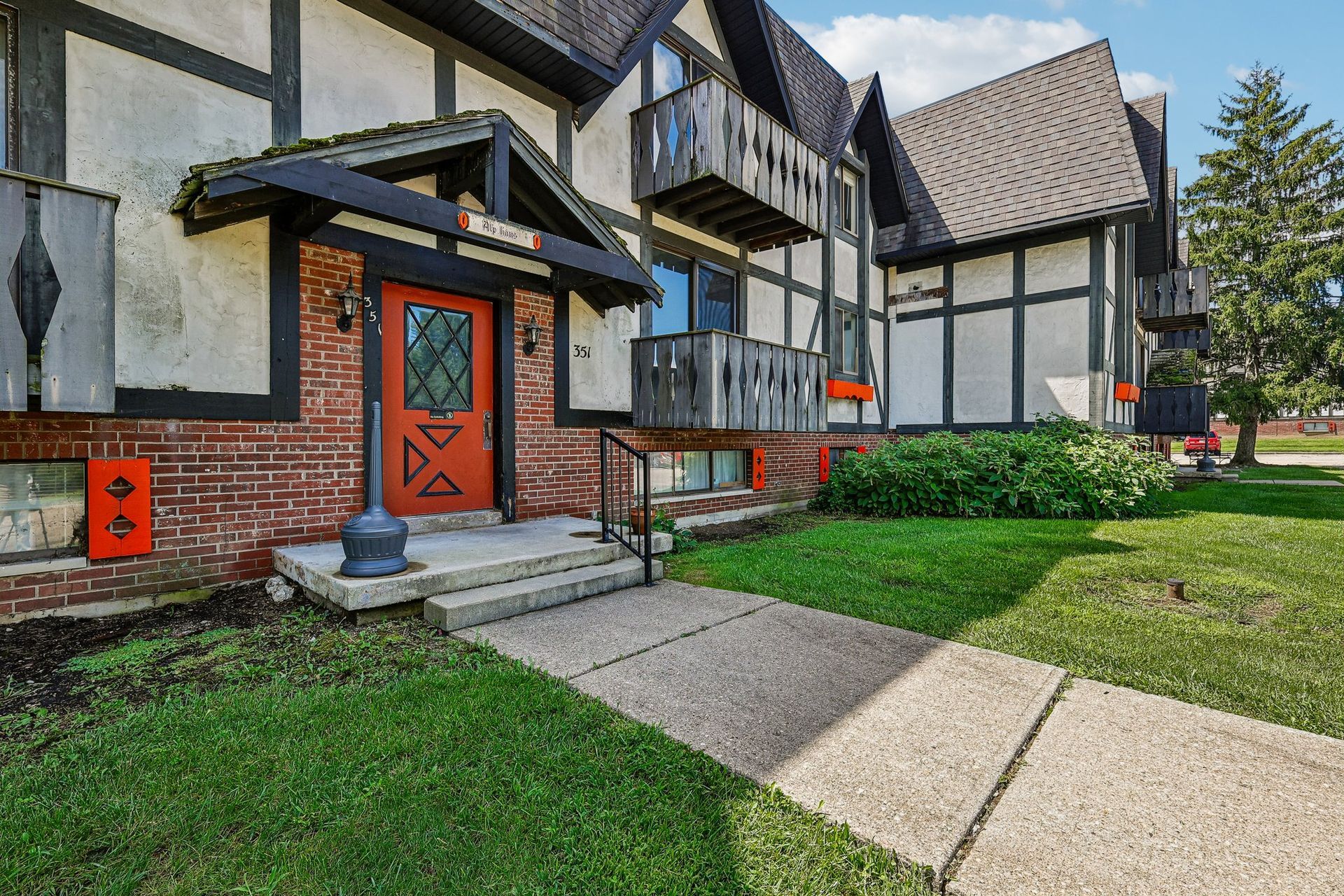 Photo of an apartment building showing a combination of brick, wood and other materials used