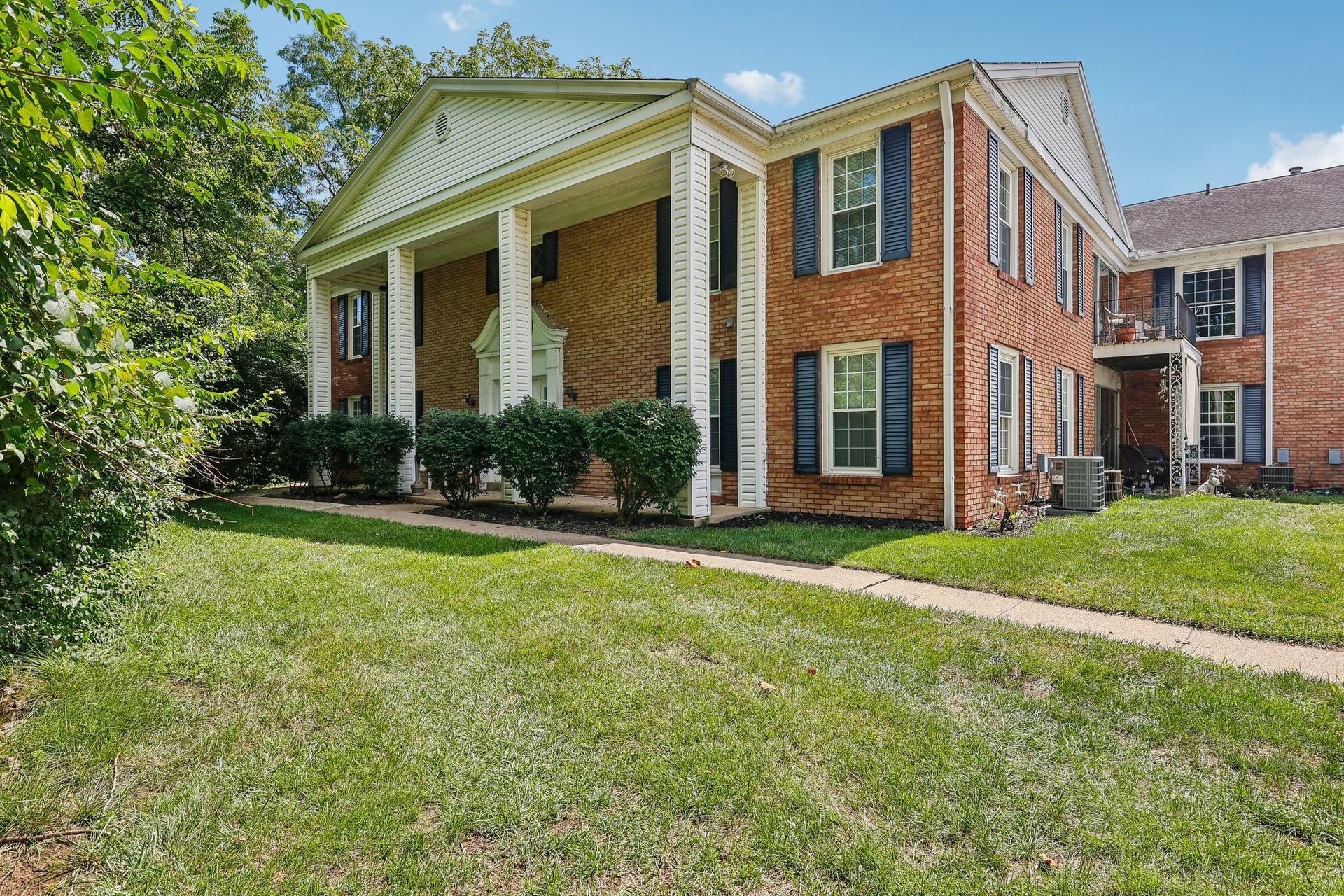 Photo of an apartment buildin, showing two stories in the colonial revival style