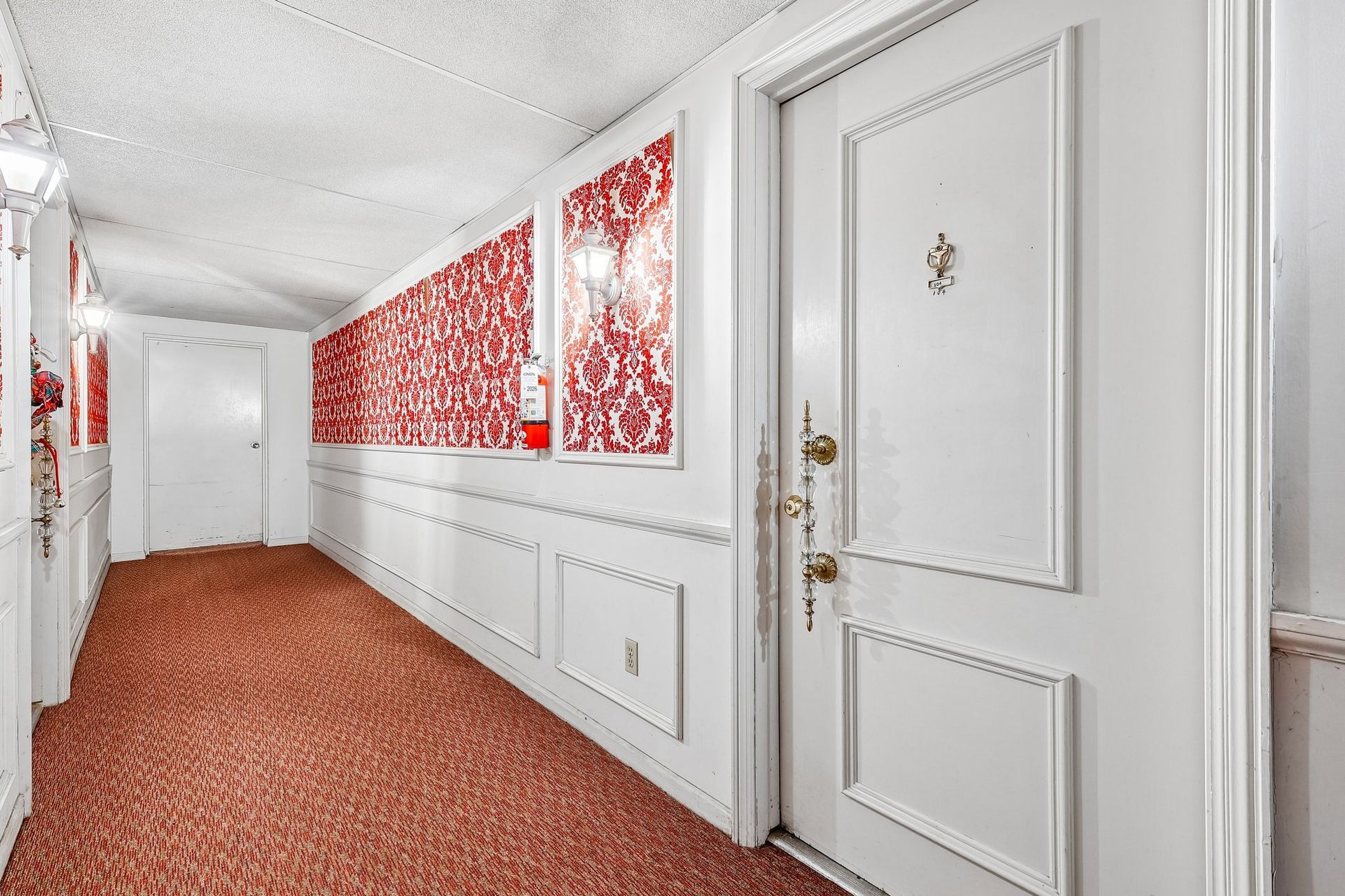 Photo of a hallway with the entrance to an apartment in the foreground