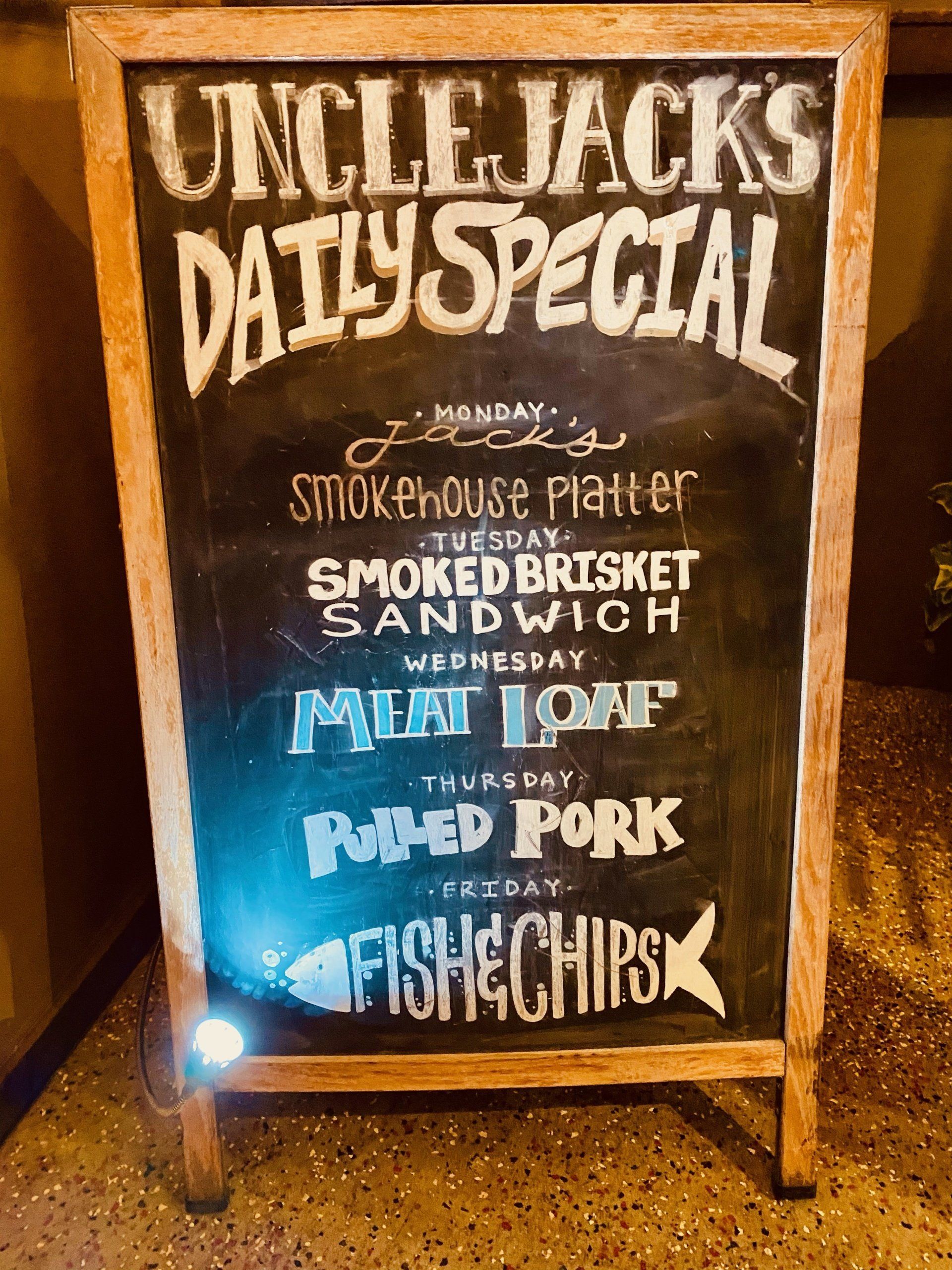 a chalkboard sign for uncle jack 's daily special