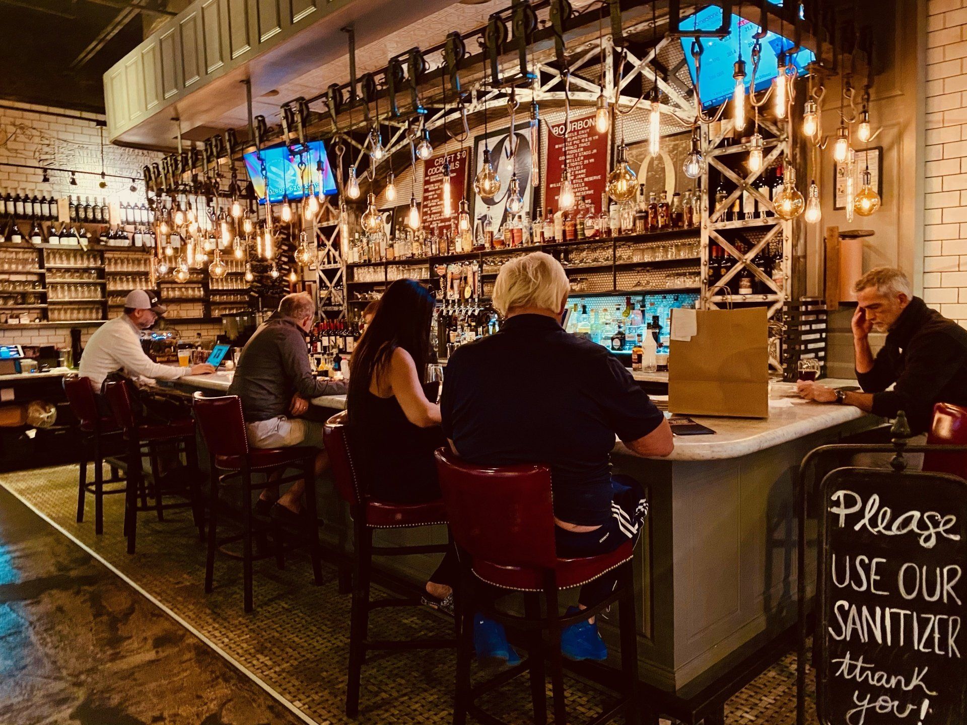 people sitting at a bar at uncle jacks meathouse duluth