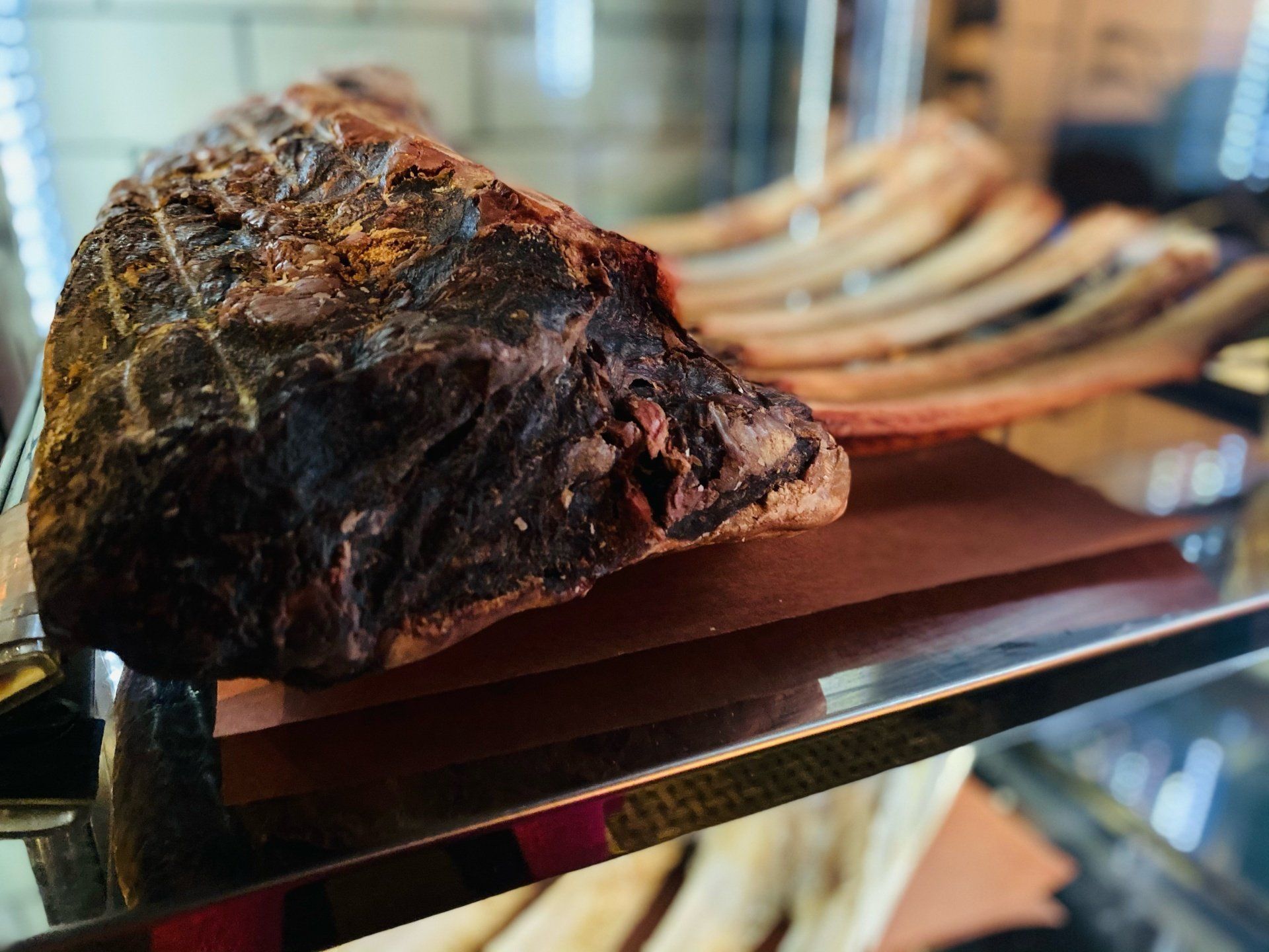 a large piece of meat is sitting on a glass shelf