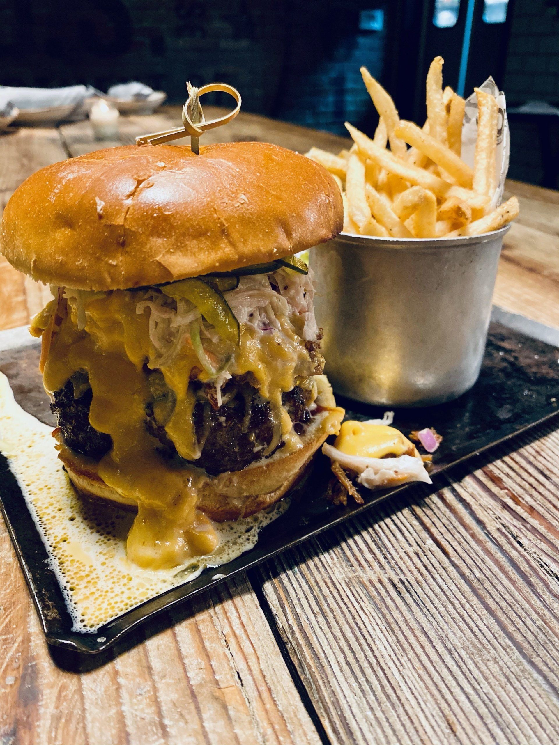 a hamburger and french fries on a wooden table