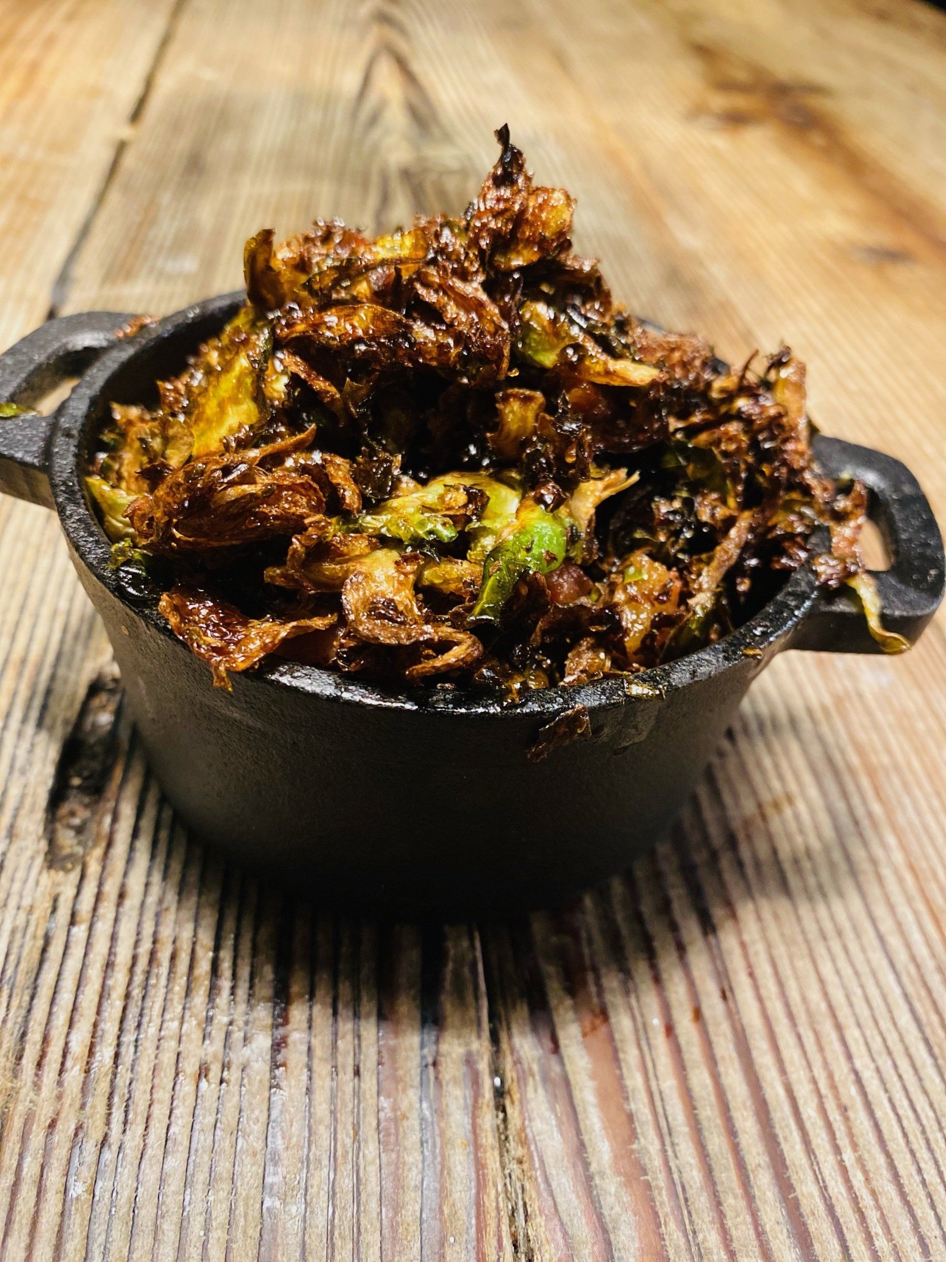 a bowl of food is sitting on a wooden table