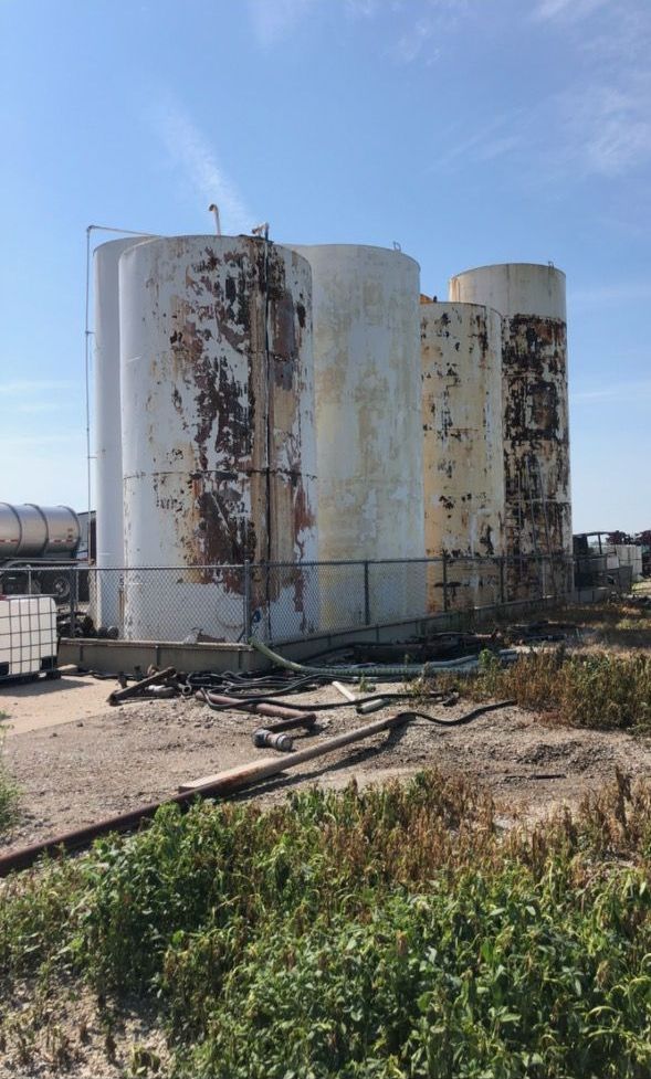 Picture of a couple really dirty storage tanks that would really benefit of a storage tank painting job. 