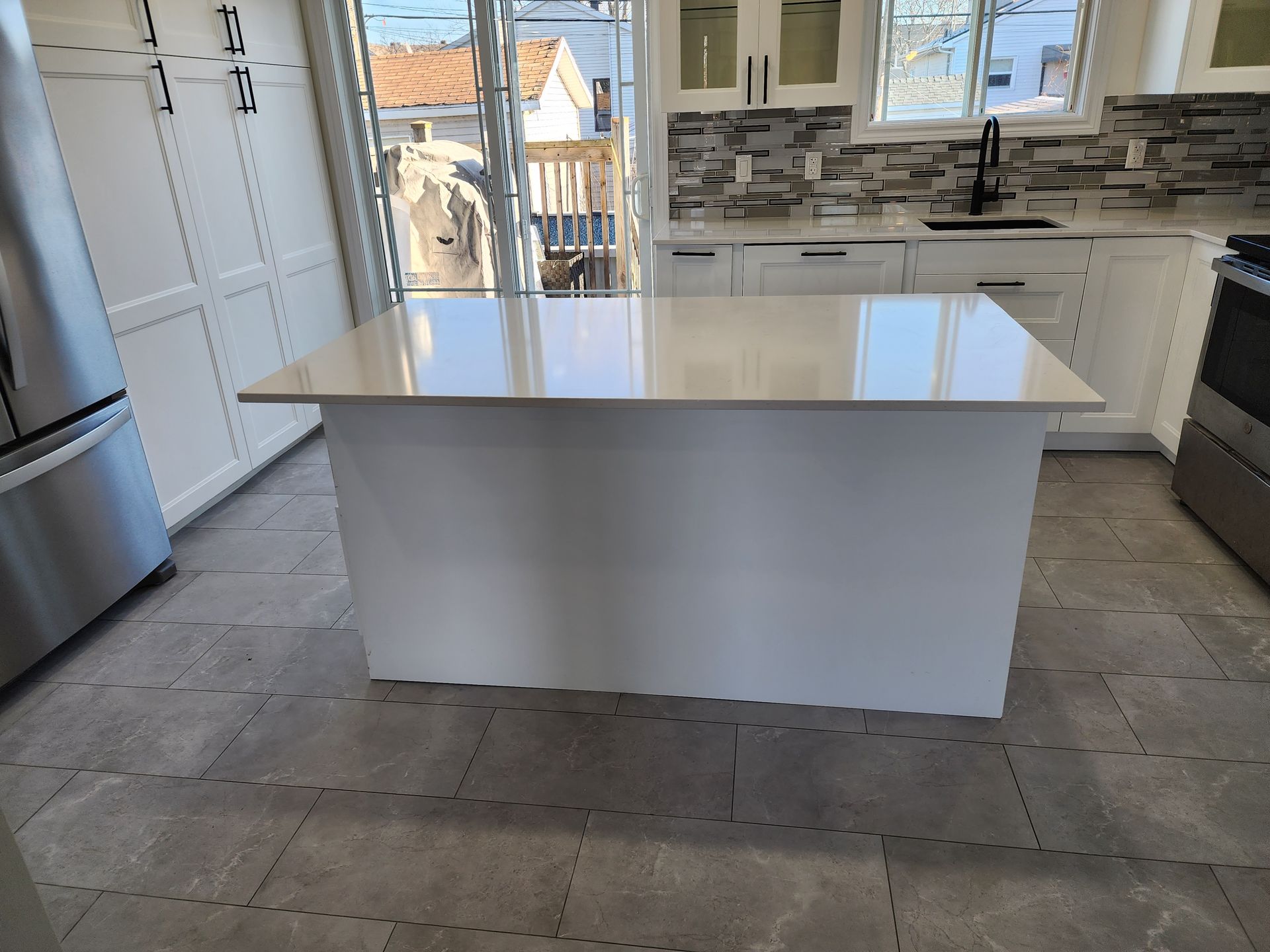 A kitchen with a large island in the middle of it.