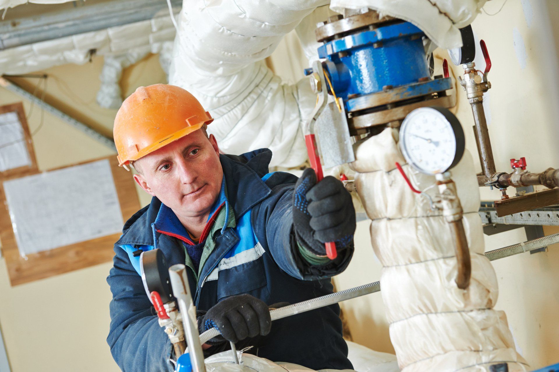 Heating Engineer Making Repairs In A Boiler Room — Somers Point, NJ — McBride & Company Plumbing, Heating, Air Conditioning