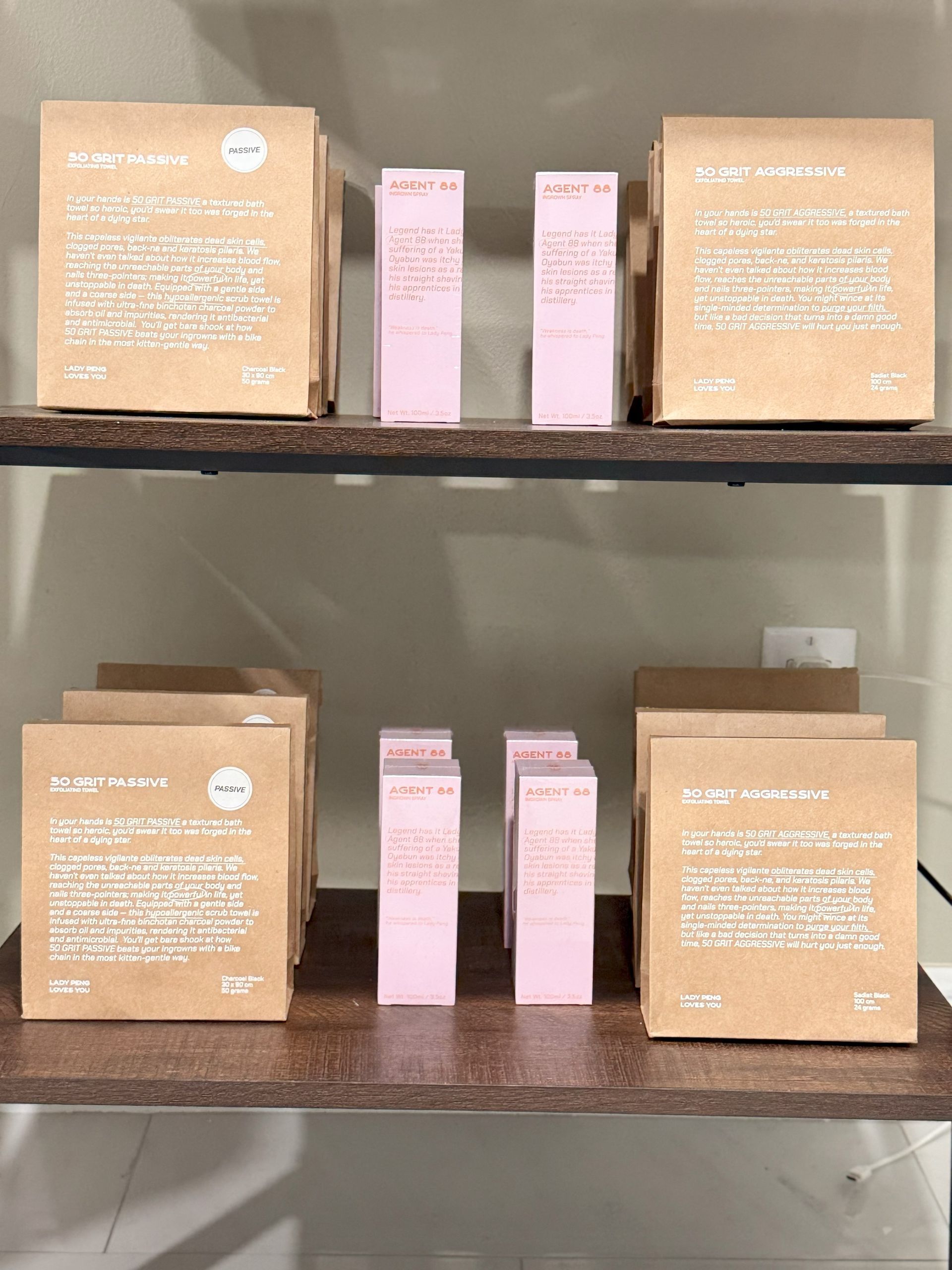 Shelves displaying skincare products in brown boxes and pink bottles.