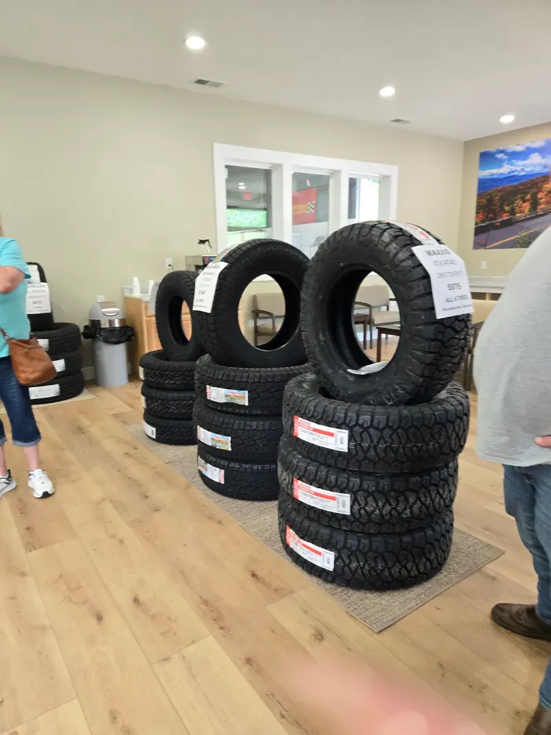 A bunch of tires are stacked on top of each other in a room.