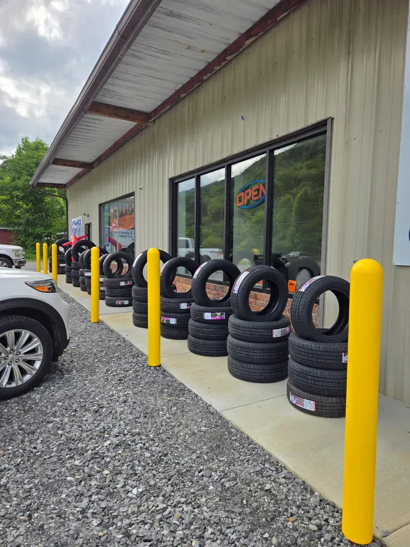 A row of tires are lined up in front of a building.
