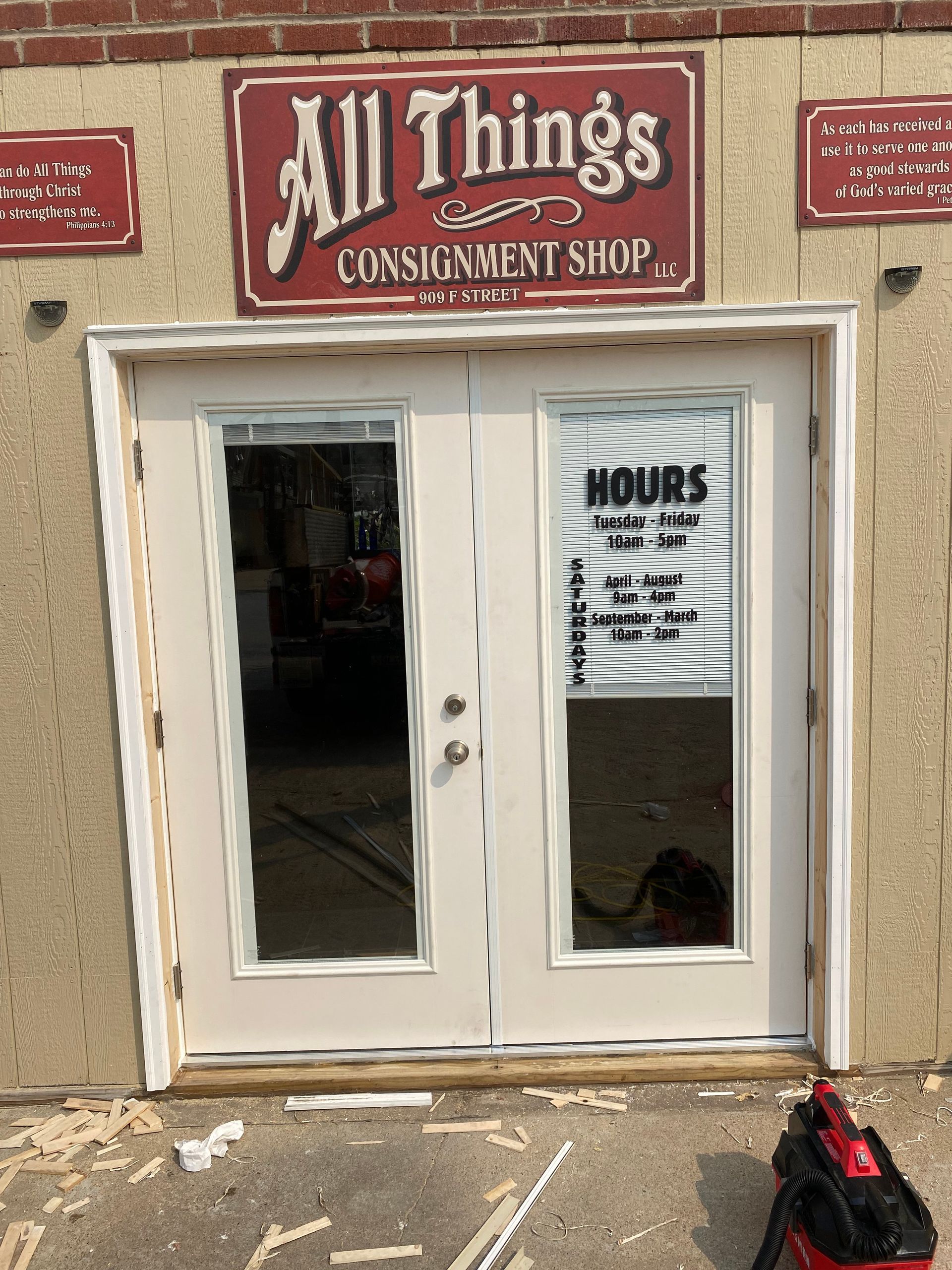 A store front with a sign that says all things consignment shop