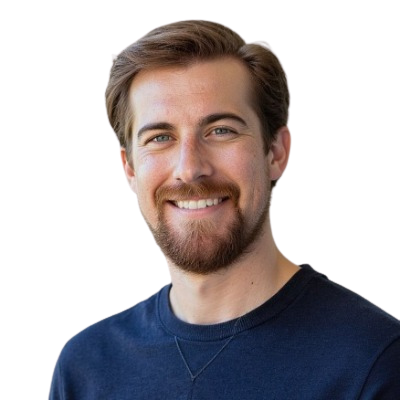 Smiling man with brown hair and beard wearing a navy shirt on a white background