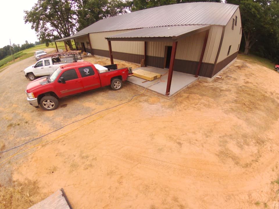 A red truck is parked in front of a building
