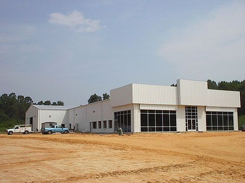 A white building with a lot of windows is being built