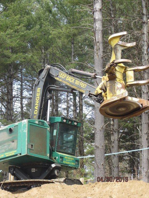 A green excavator with the word danger on the side