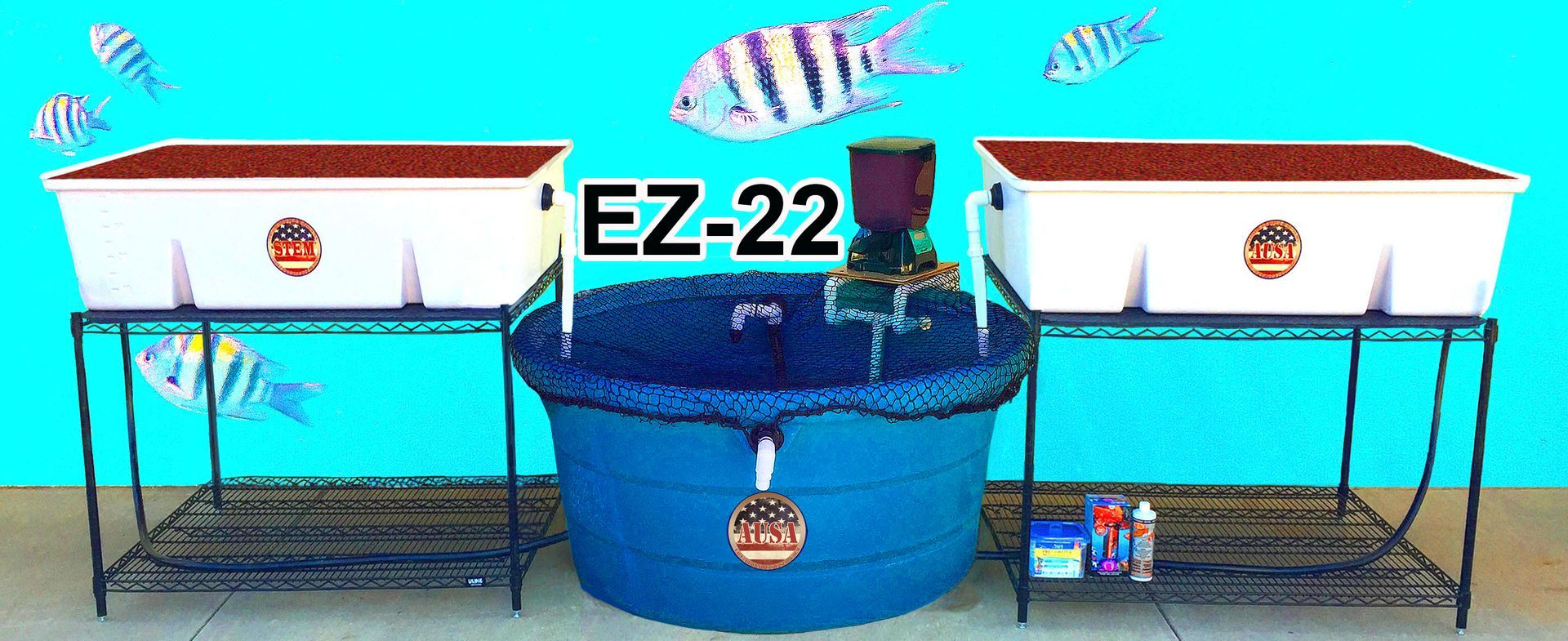 An aquaponics system with two white grow beds, a blue water tank, and fish.