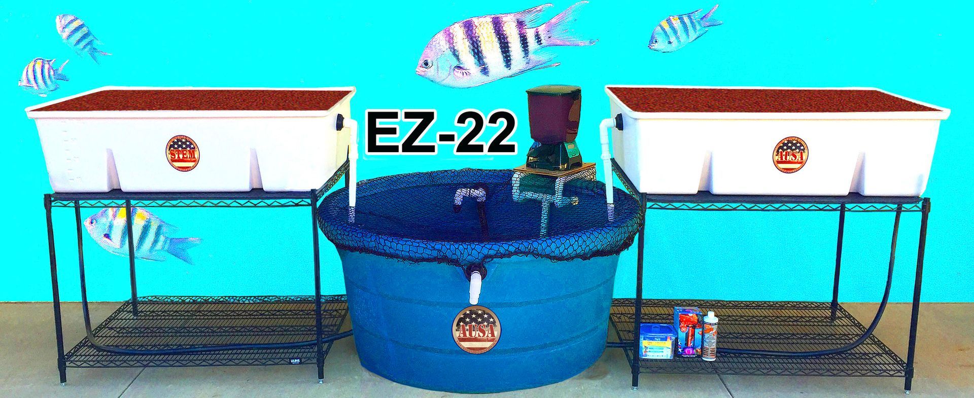 An aquaponics system with white containers and a blue water tank, fish decorations, and 