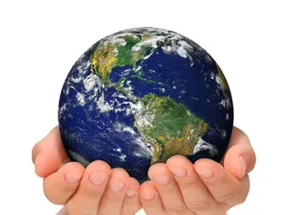 A person is holding a globe in their hands