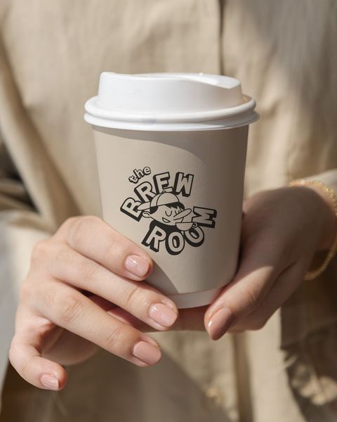 The Brew Room mascot on a cup