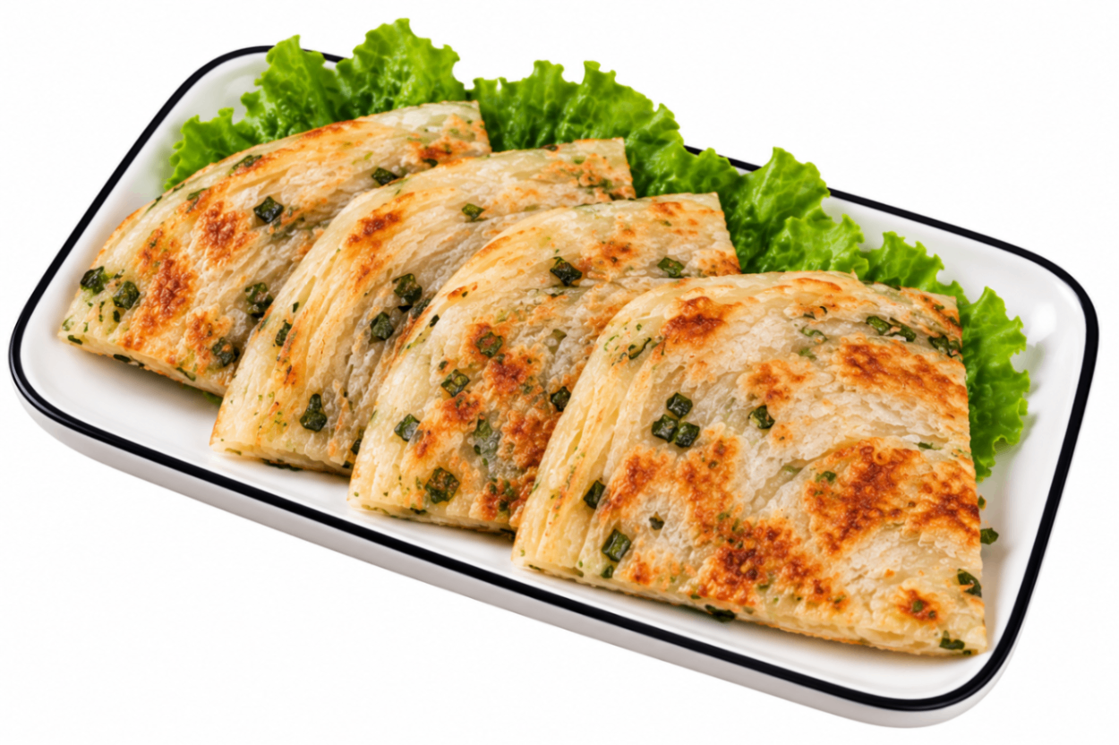 Sliced grilled chicken breast on a white platter with lettuce garnish