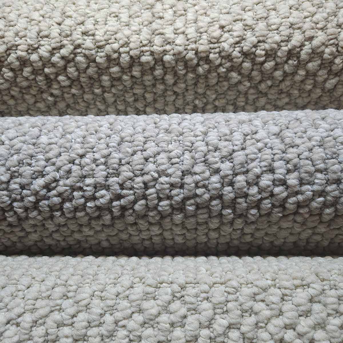 A Close up Of Three Rolls of Carpet Stacked on Top of Each Other — Kelwin Coastal Carpets In Kundra Park, QLD