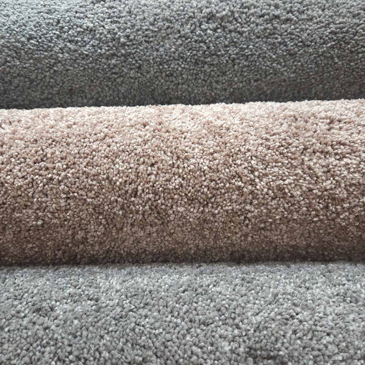 A Close up Of Three Rolls of Carpet in Different Colors — Kelwin Coastal Carpets In Kundra Park, QLD