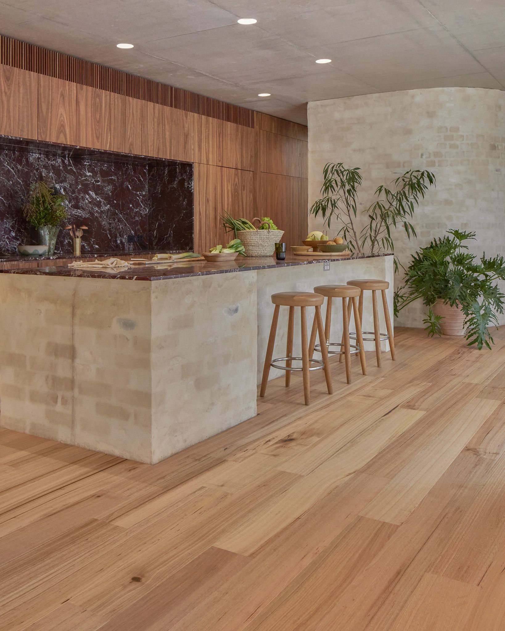 A Kitchen with White Cabinets, Wooden Floors, and Stools — Kelwin Coastal Carpets In Kundra Park, QLD