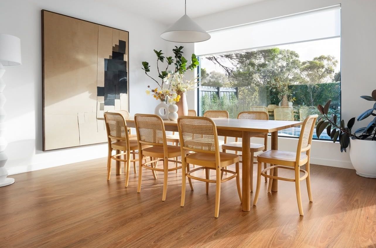 A Living Room with Hardwood Floors, a Couch, Two Tables and A Painting on The Wall  — Kelwin Coastal Carpets In Kundra Park, QLD