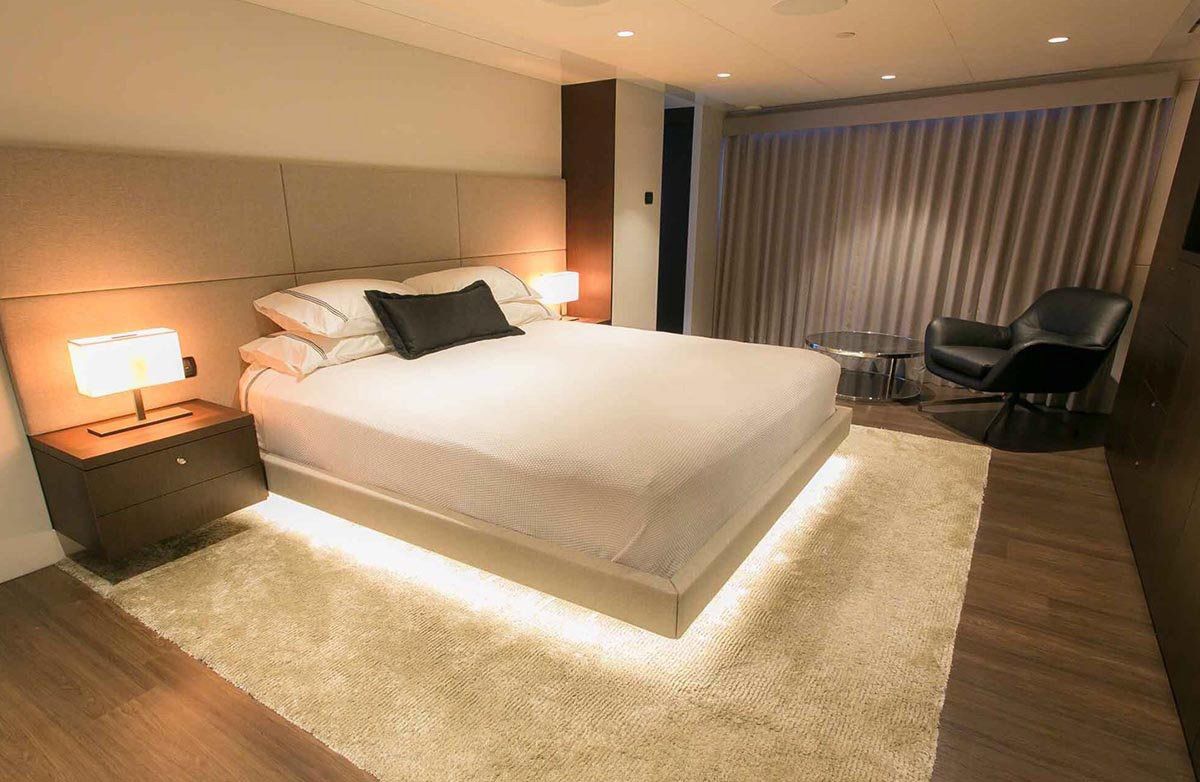 A Bedroom with A Bed, Chair, Nightstand and Rug — Kelwin Coastal Carpets In Kundra Park, QLD