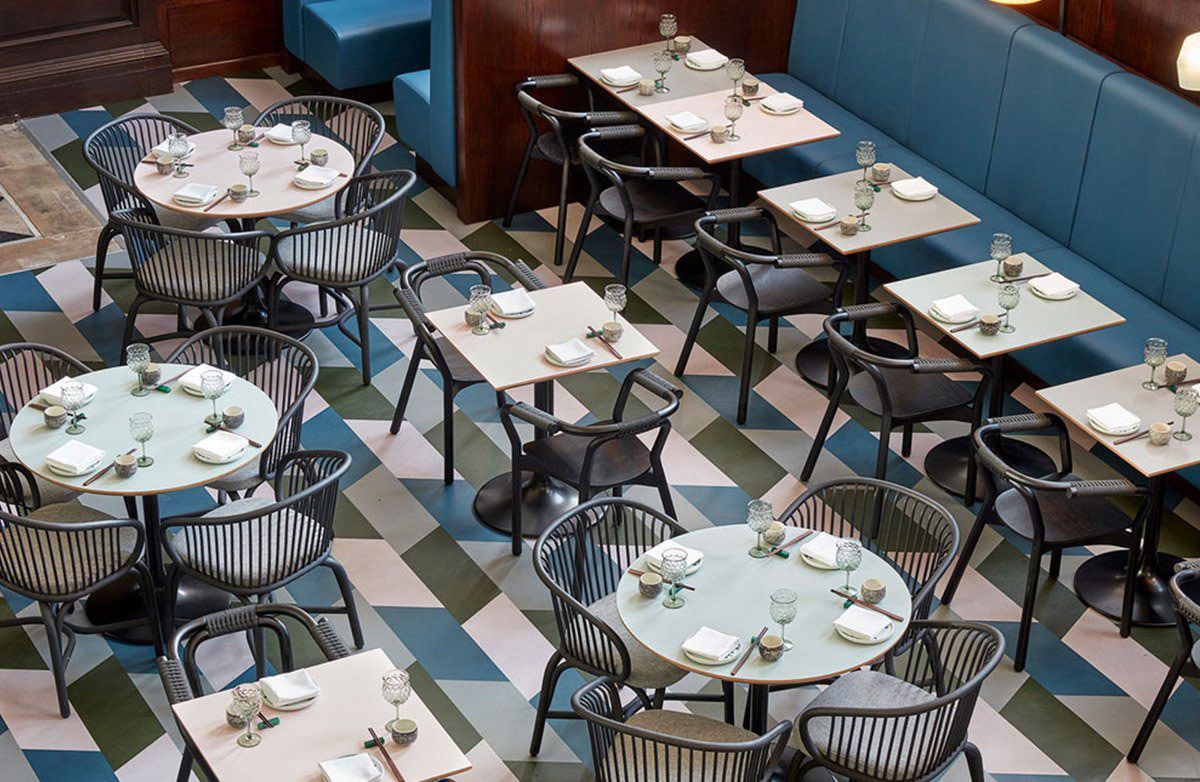 A Restaurant with Tables, Chairs and A Checkered Floor — Kelwin Coastal Carpets In Kundra Park, QLD