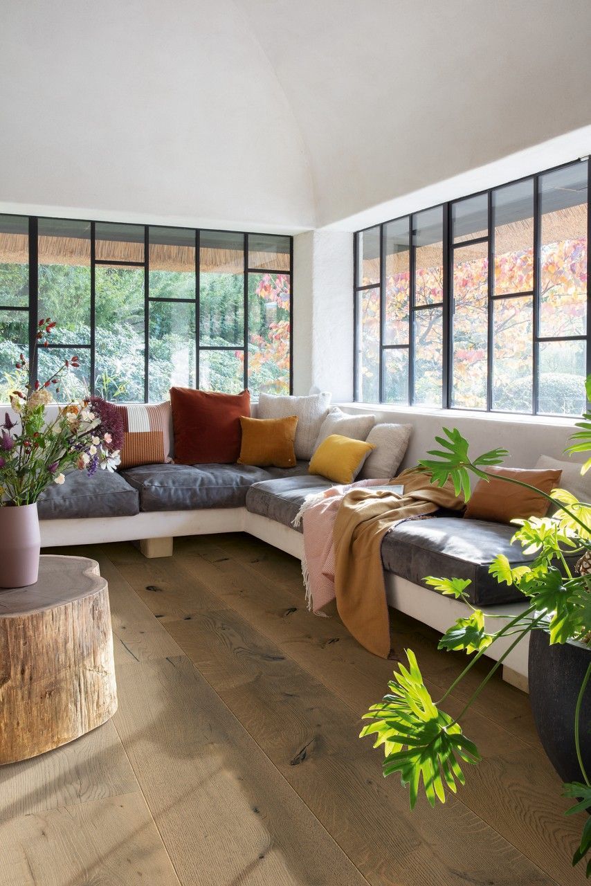 A Living Room with A Chair and A Balcony Overlooking the Ocean  — Kelwin Coastal Carpets In Kundra Park, QLD