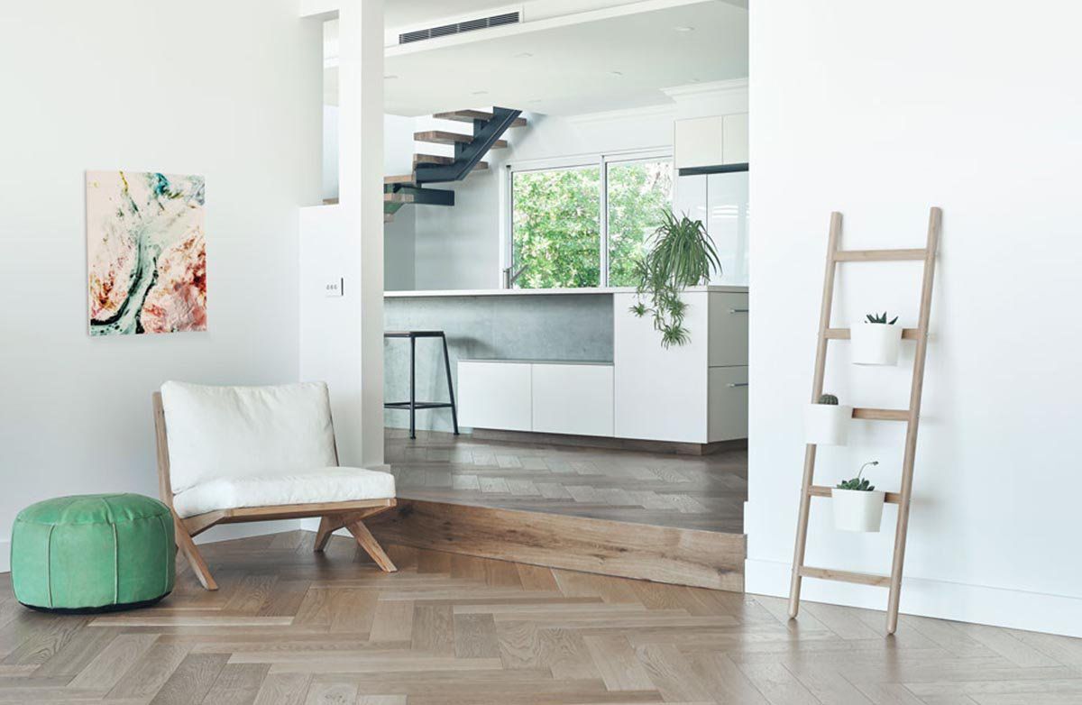 A Kitchen with White Cabinets, Wooden Floors, and Stools — Kelwin Coastal Carpets In Kundra Park, QLD