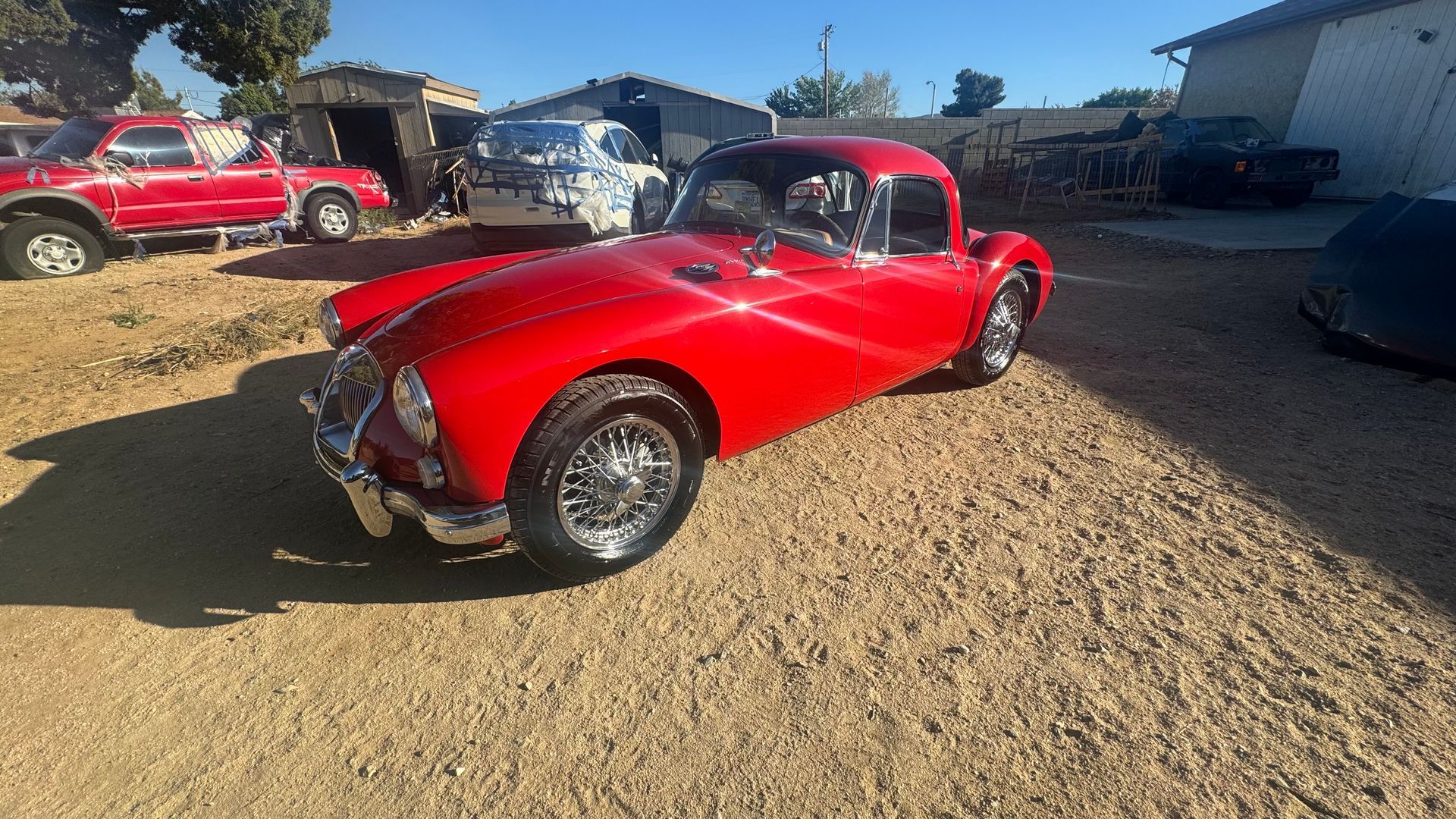 Red vintage car parked outside on a sunny day. | Alberto's Transmissions & Auto