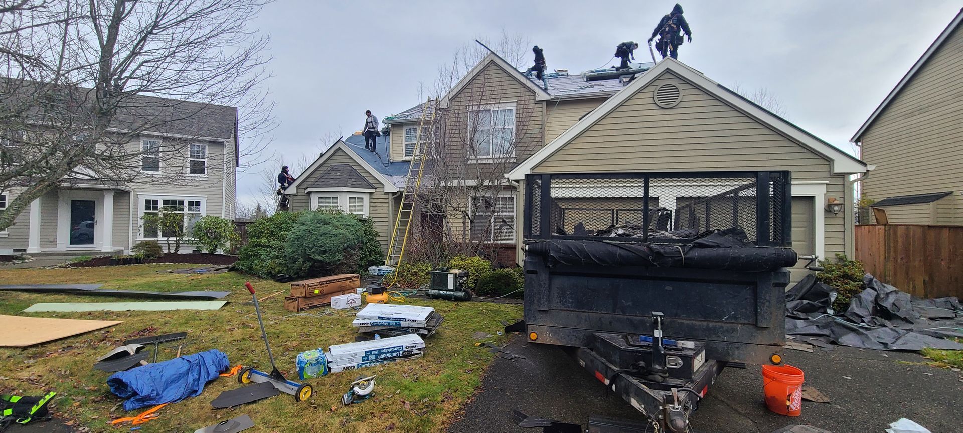 Backyard with a damaged fire pit and scattered debris near houses after a storm